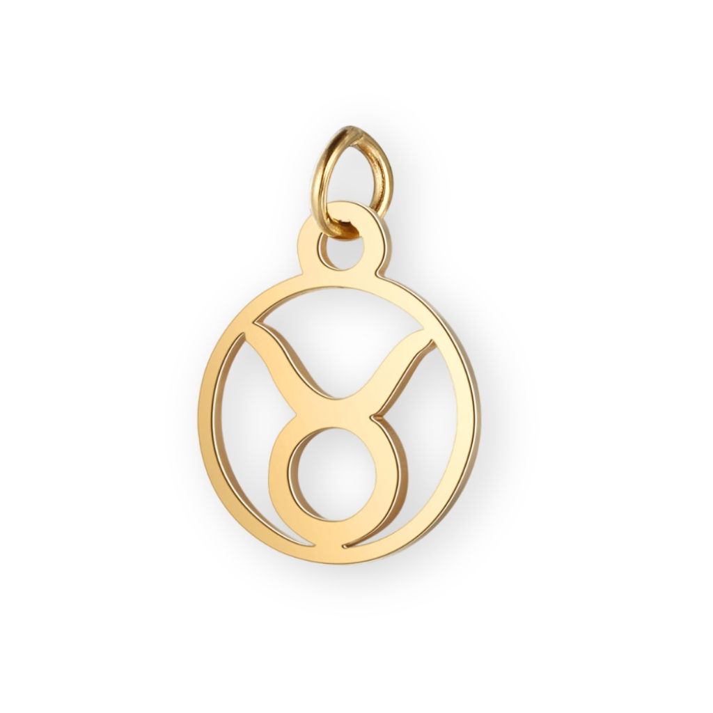 Un pendentif en or pour bola de grossesse de femme enceinte représentant le signe astrologique du taureau